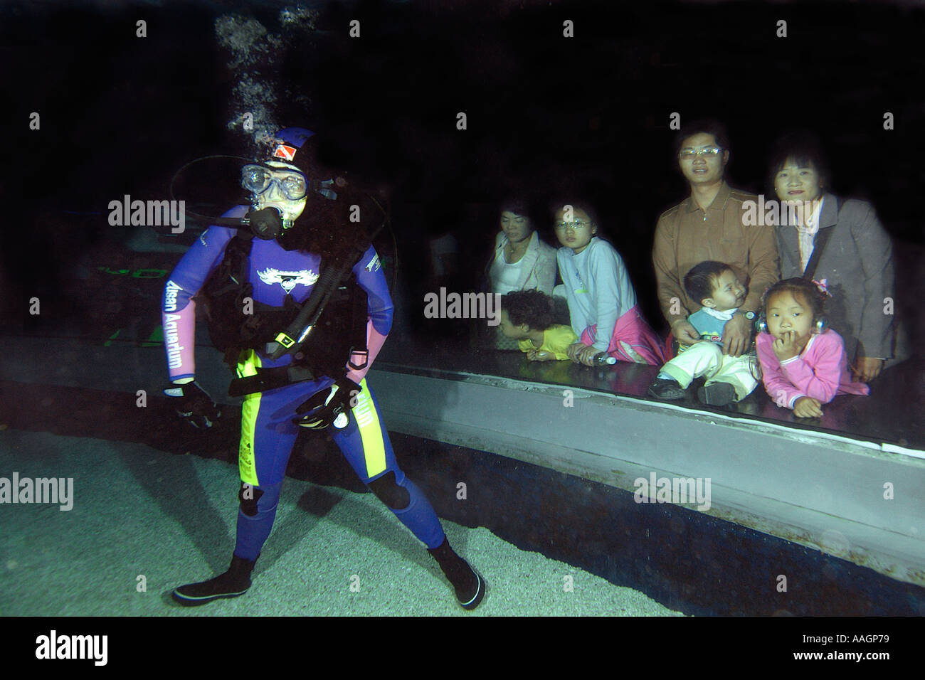 Scuba diver stands next to Korean family Busan aquarium Busan South Korea Stock Photo