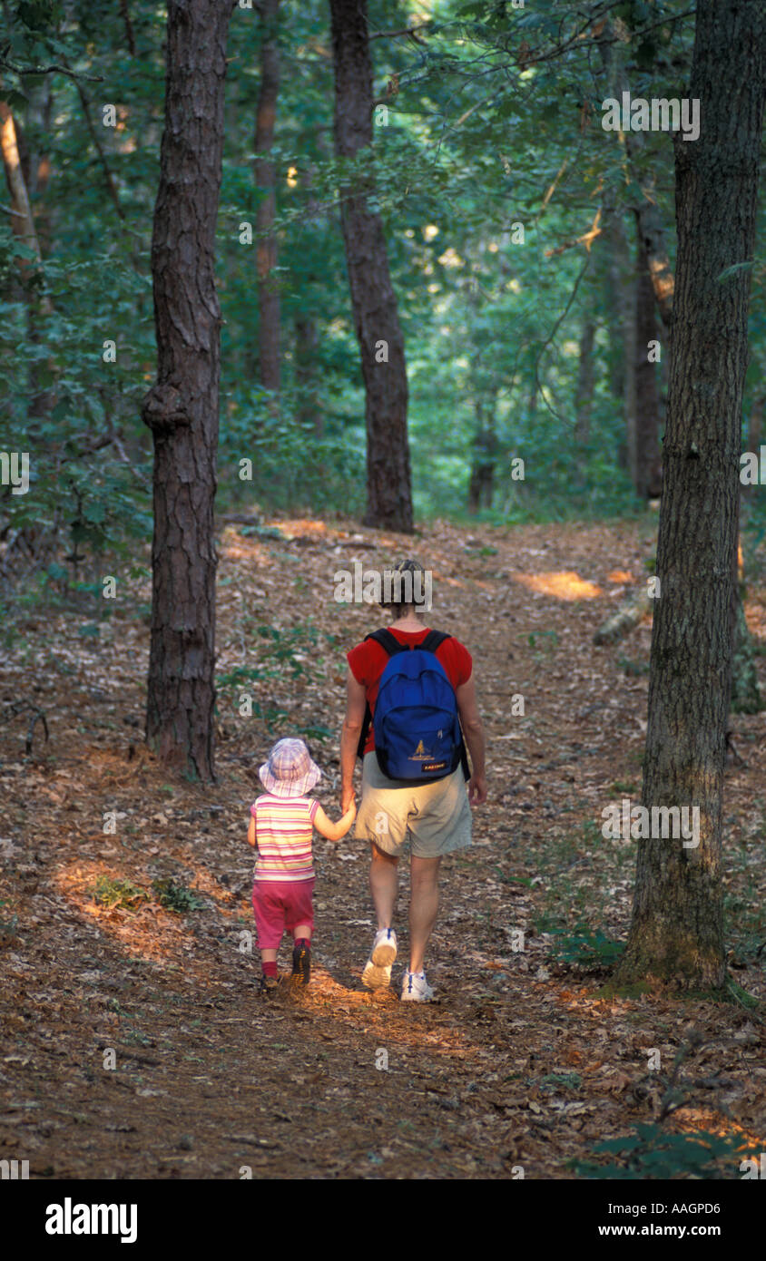 Harwich MA A woman and her daughter walk a trail in the oak pine forest
