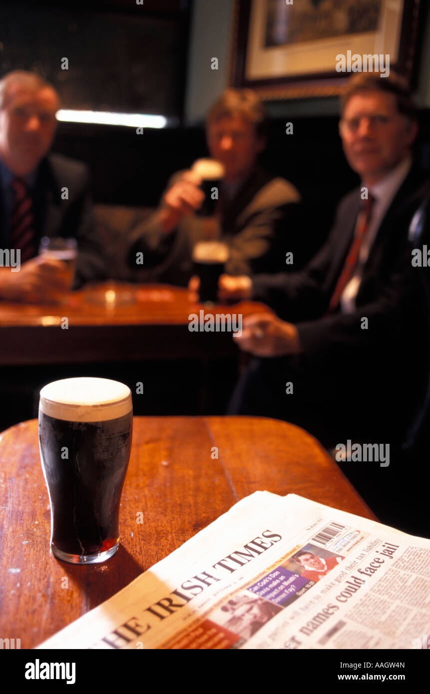 Three businessmen sitting in The Old Stand Pub glass of Guinness and a
