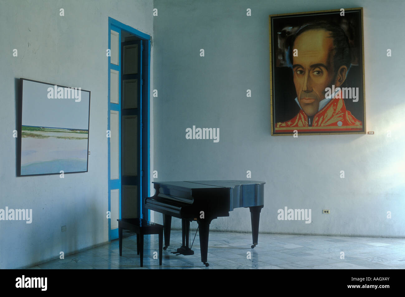 Cuba Havana piano in an empty room with a large portrait hanging on the wall Stock Photo