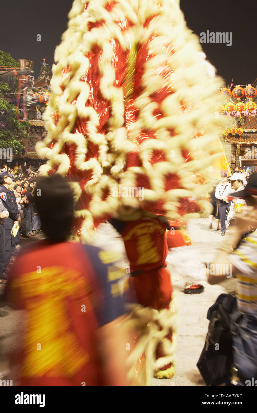 Man Holding Chinese Dragon Walking Into Temple Stock Photo