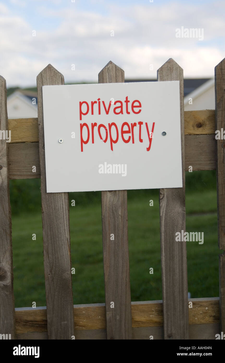 Private property sign on garden gate of house - red lettering on white background Stock Photo