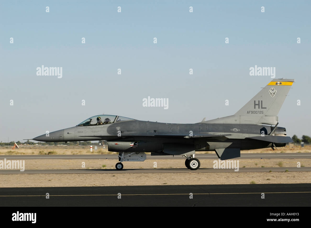 Side View of F-16 Falcon Jet Fighter Taxiing on Runway Stock Photo