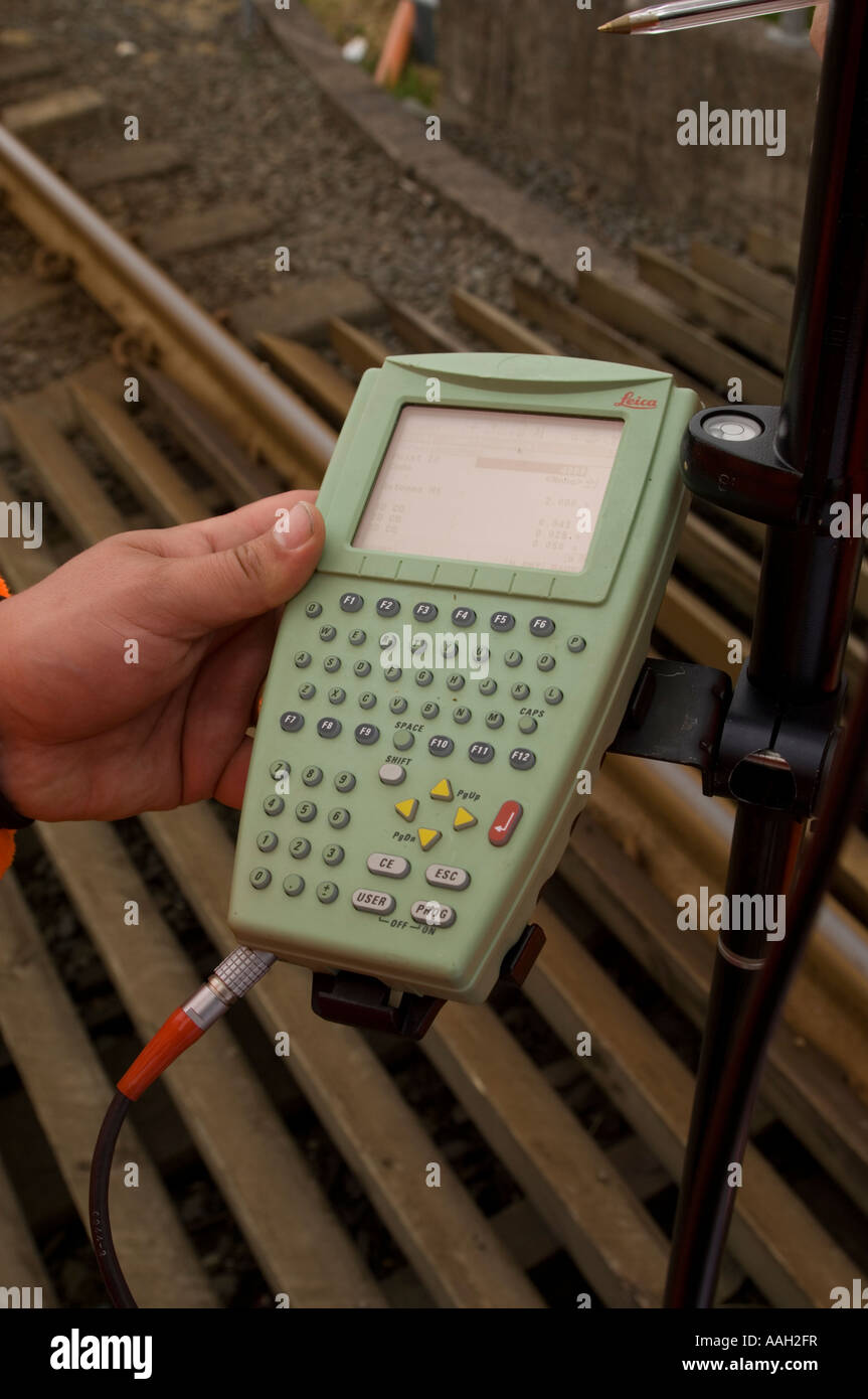 Person holding global positioning system GPS handset to locate the position with sn accuracy of  10cm Stock Photo