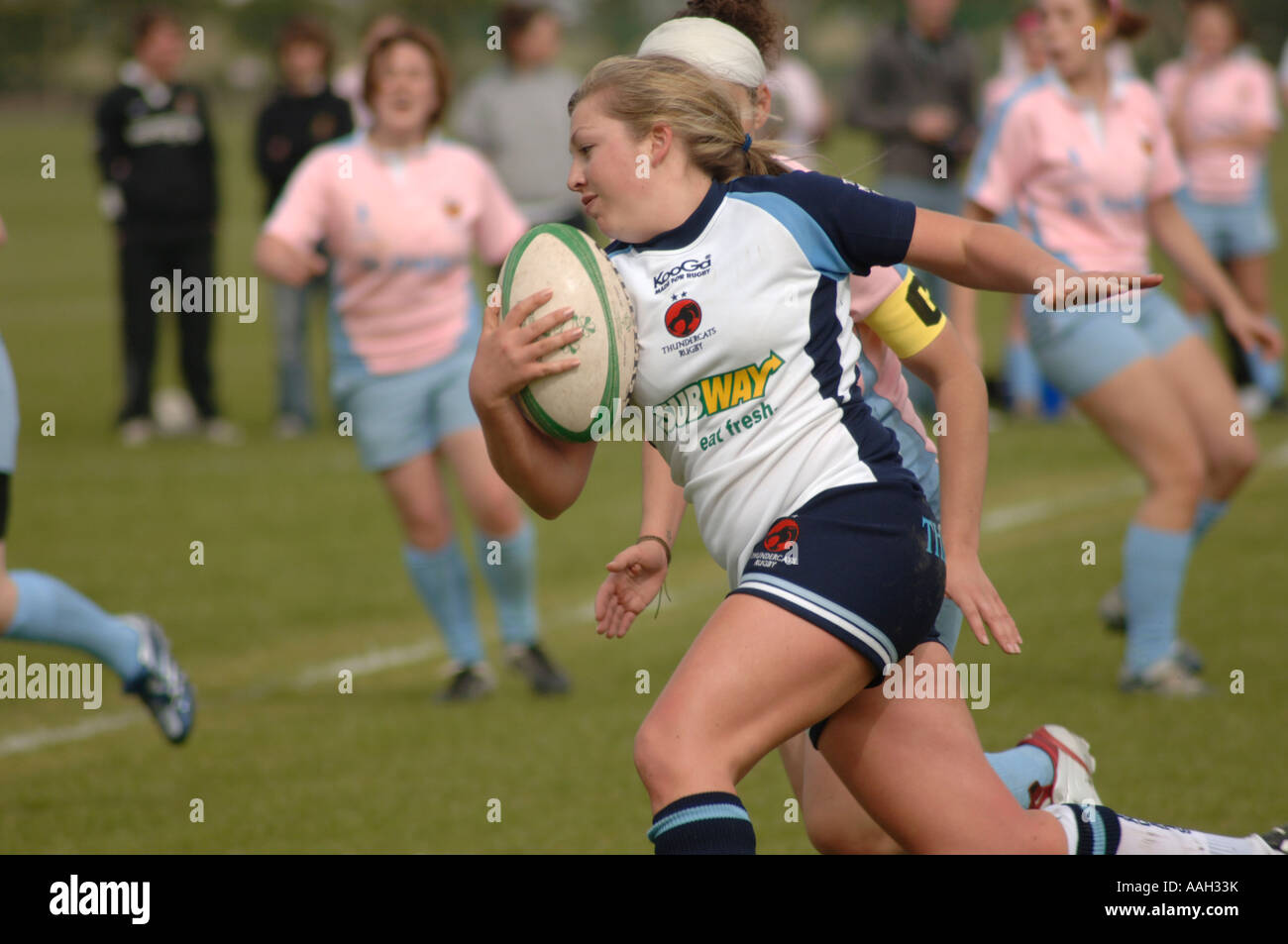 women playing rugby aberystwyth university - a woman in kit sponsored by Subway sandwich bar running with ball in her hands UK Stock Photo