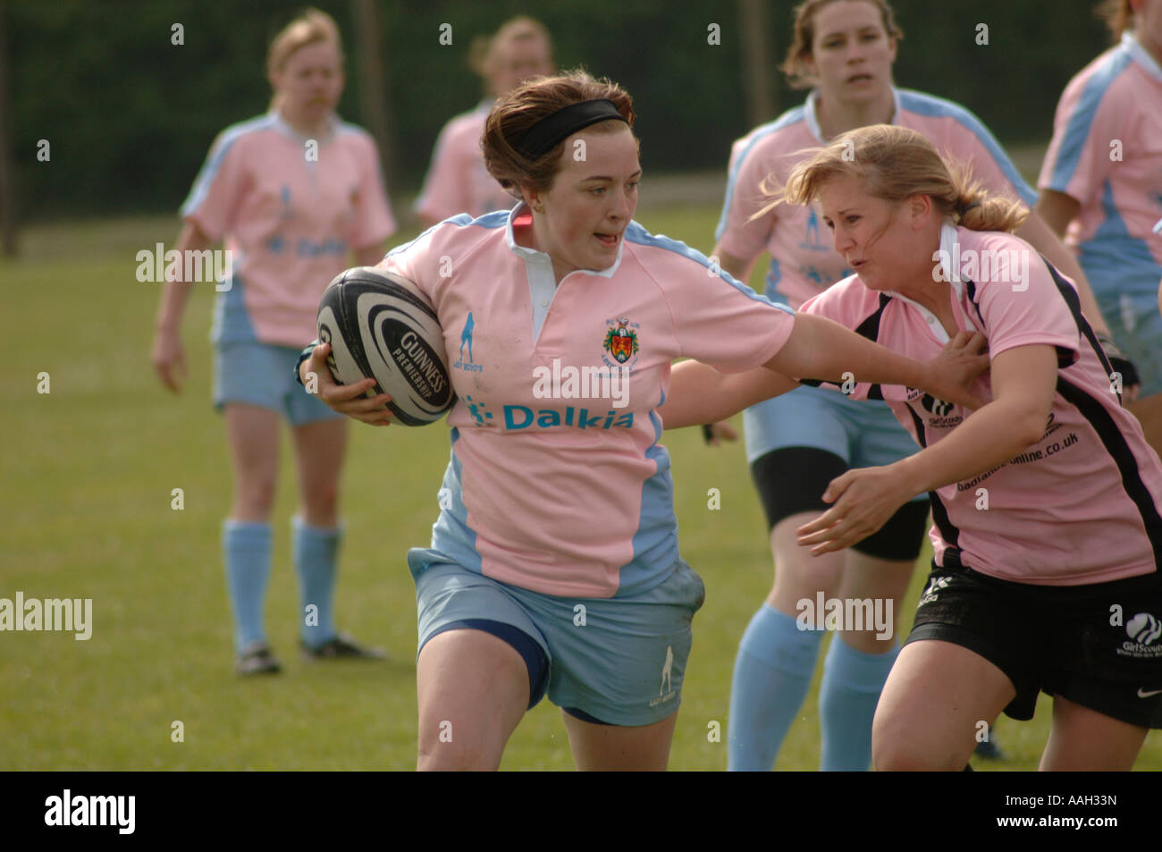 women playing rugby aberystwyth university - girl handing off a tackle from member of opposing team Stock Photo