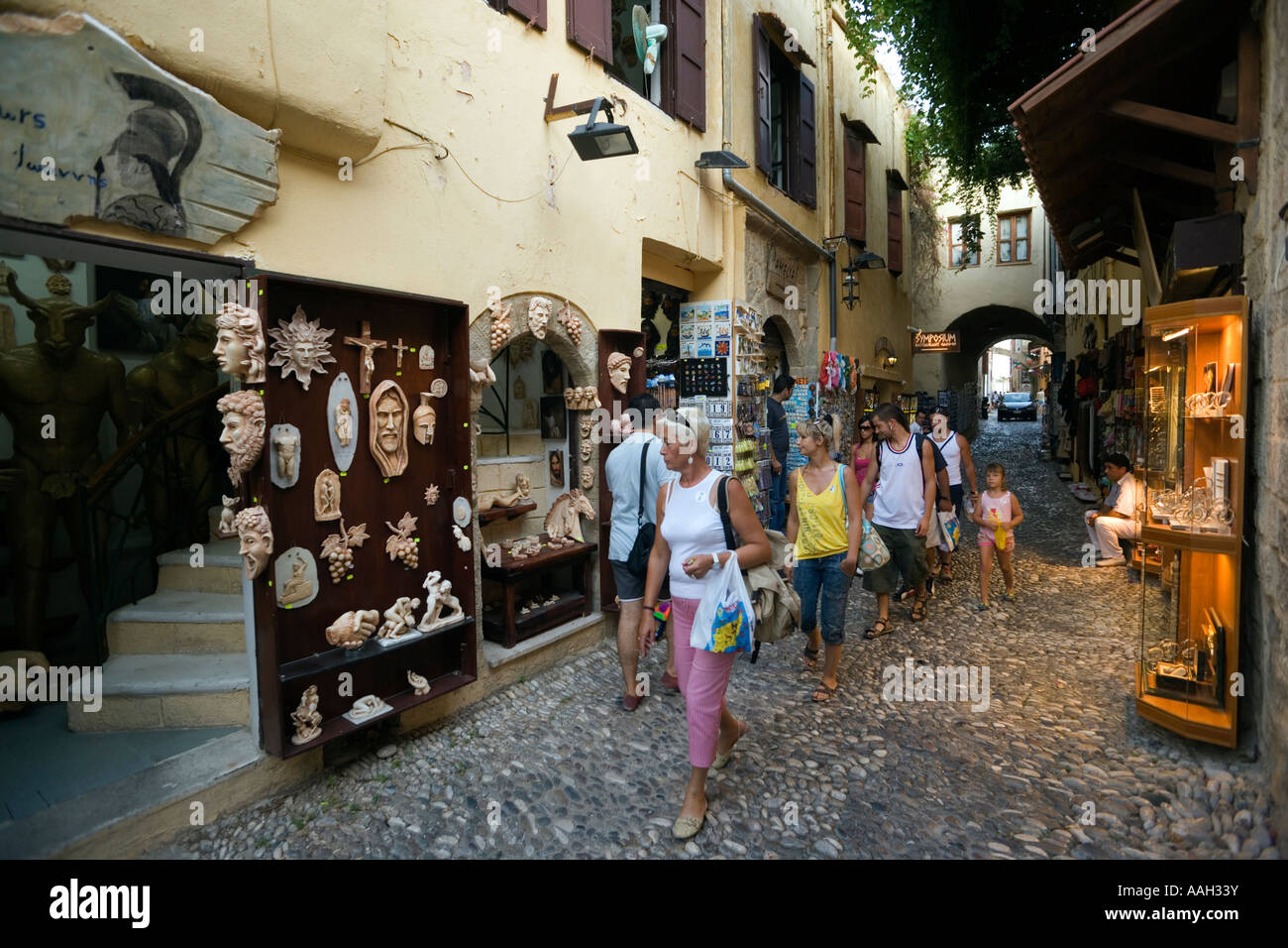 People strolling along souvenir shops through old town Rhodes Town ...