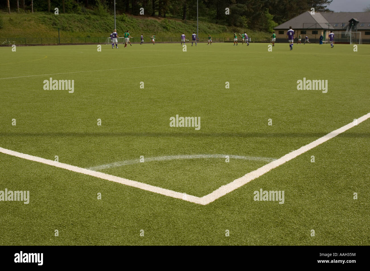 men playing hockey on artificial all weather surface Aberystwyth University - obtuse angle marked out on corner  the pitch, wale Stock Photo