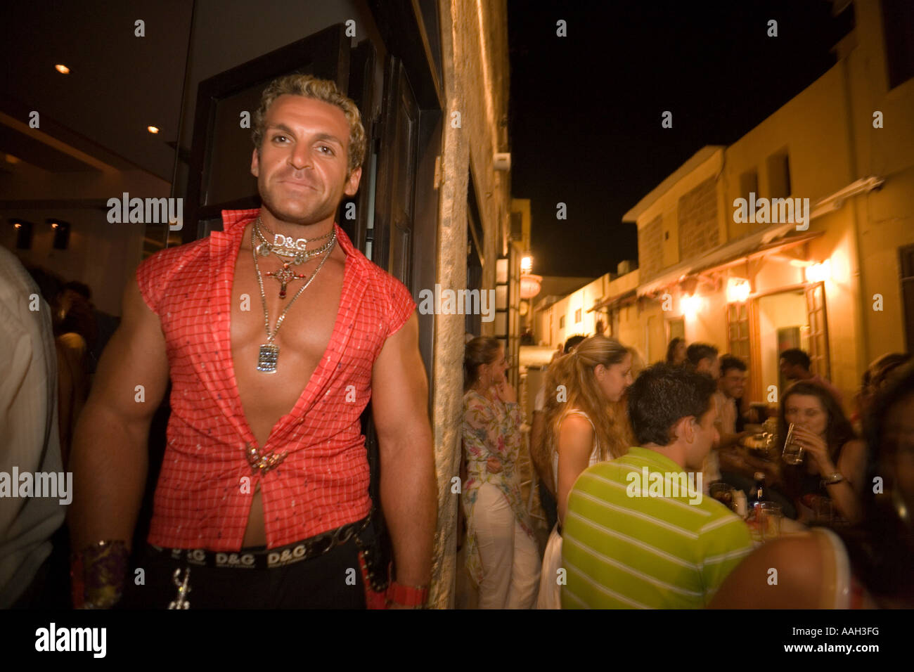 Portrait of a muscular bouncer in front of a bar old town Rhodes Town