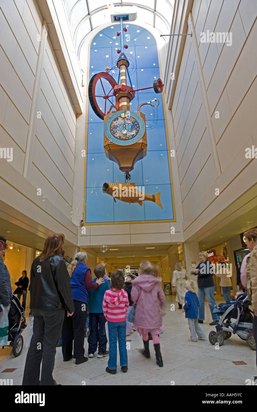 Shoppers looking at the Wishing Fish Clock Regent Arcade Cheltenham