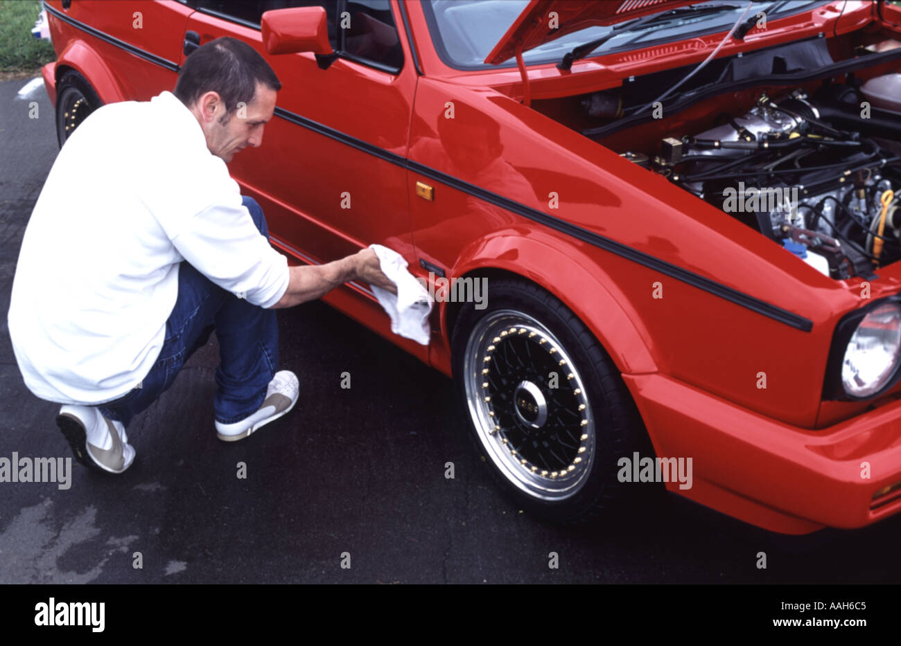 Car enthusiast cleaning his Volkswagen Golf MK1 car, Rendlesham