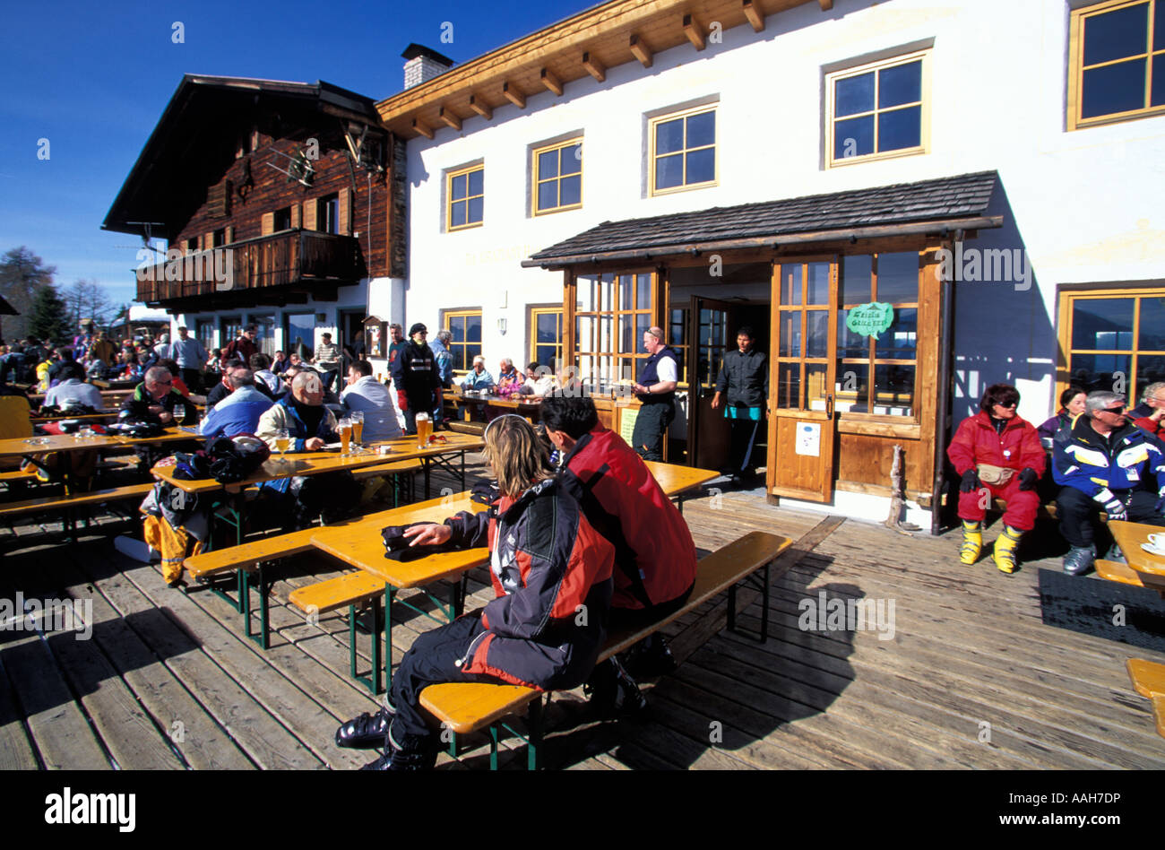 People sitting on terrace of Graziani hut Plan de Corones Dolomites Bolzano South Tyrol Italy Stock Photo