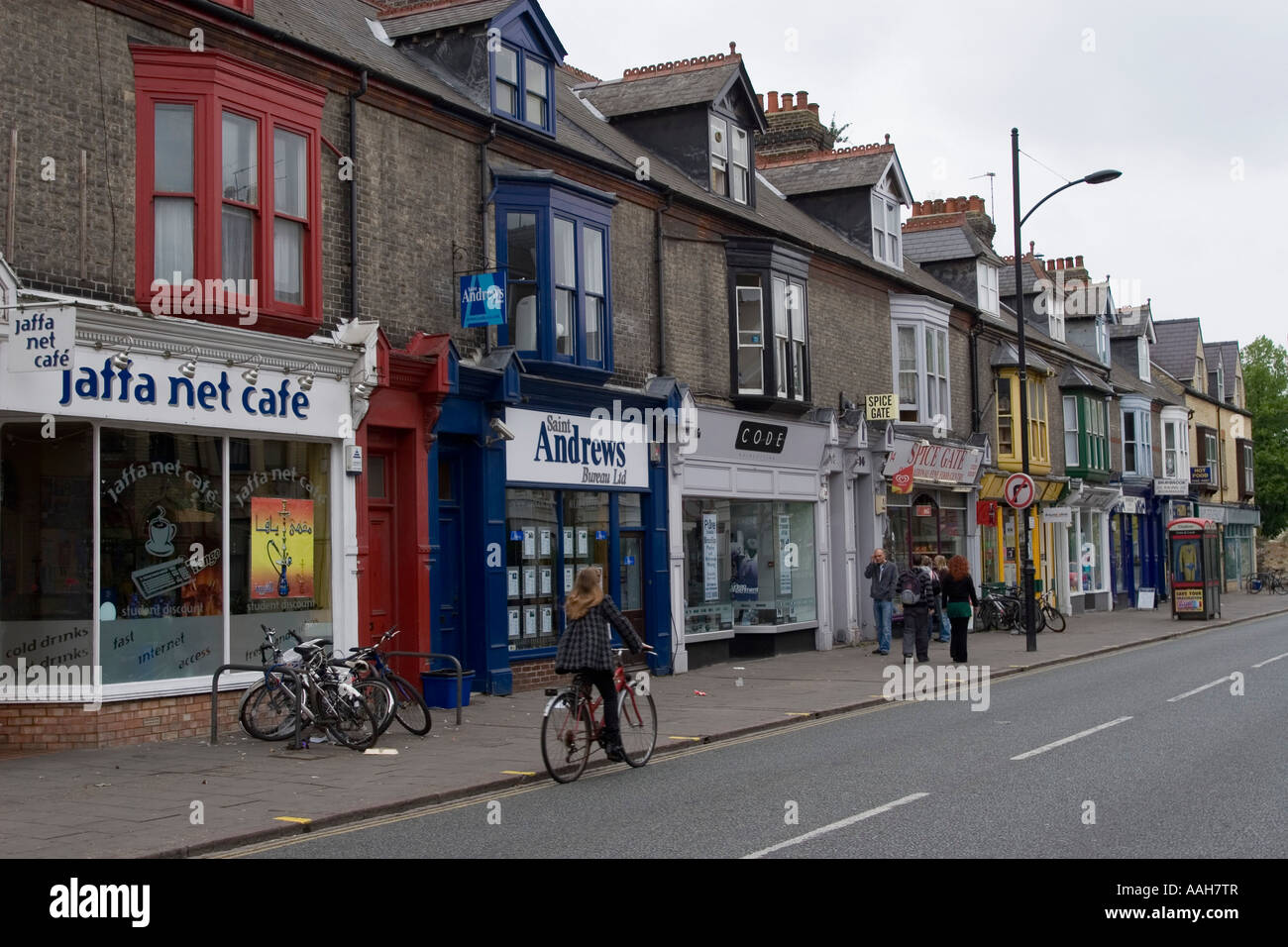 Internet cafe on Mill road with cyclist Cambridge England Stock Photo