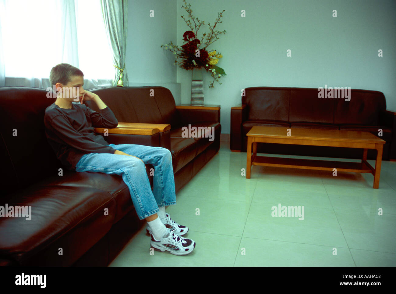 Sad depressed boy alone in room Stock Photo - Alamy