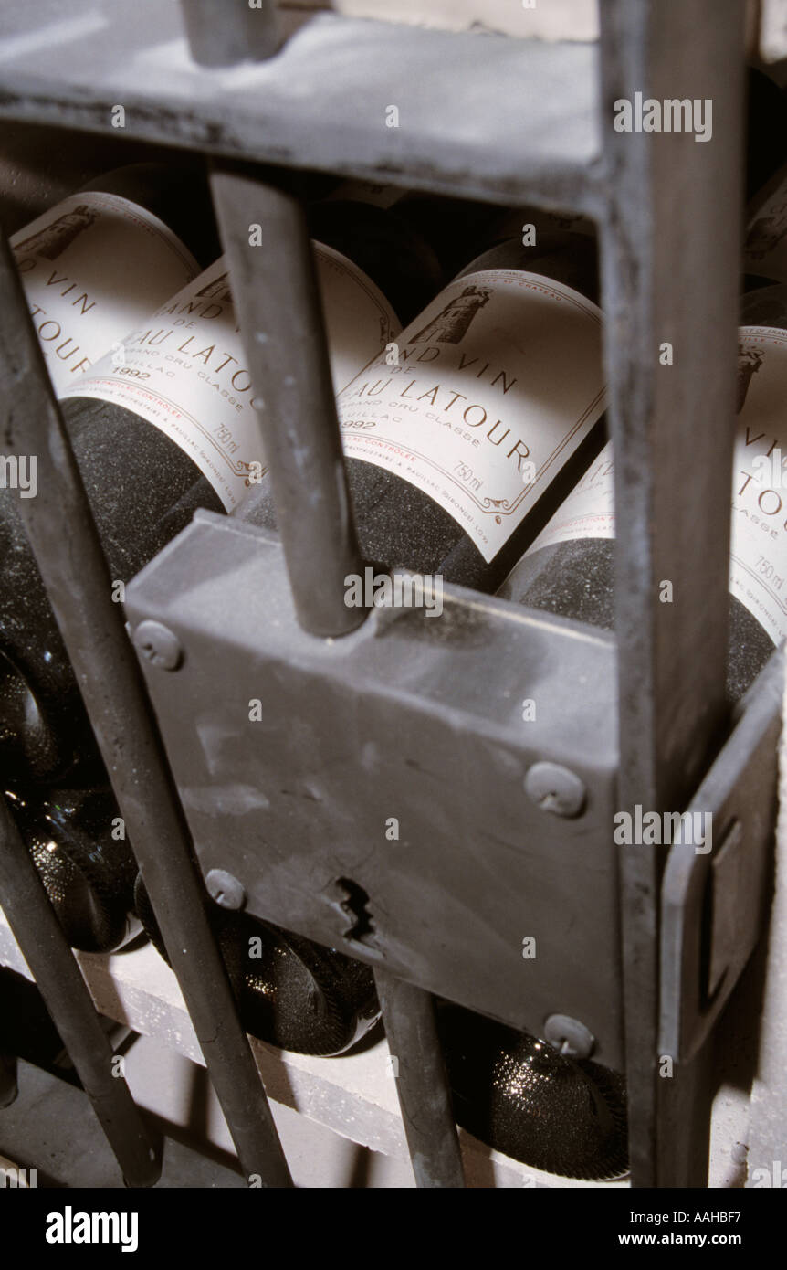 expensive bottles locked up behind bars in a wine cellar Stock Photo