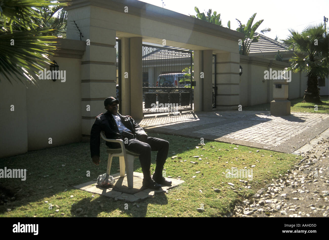 Tired Guard on duty outside luxury home in Rosebank a suburb of Johannesburg South Africa Stock Photo