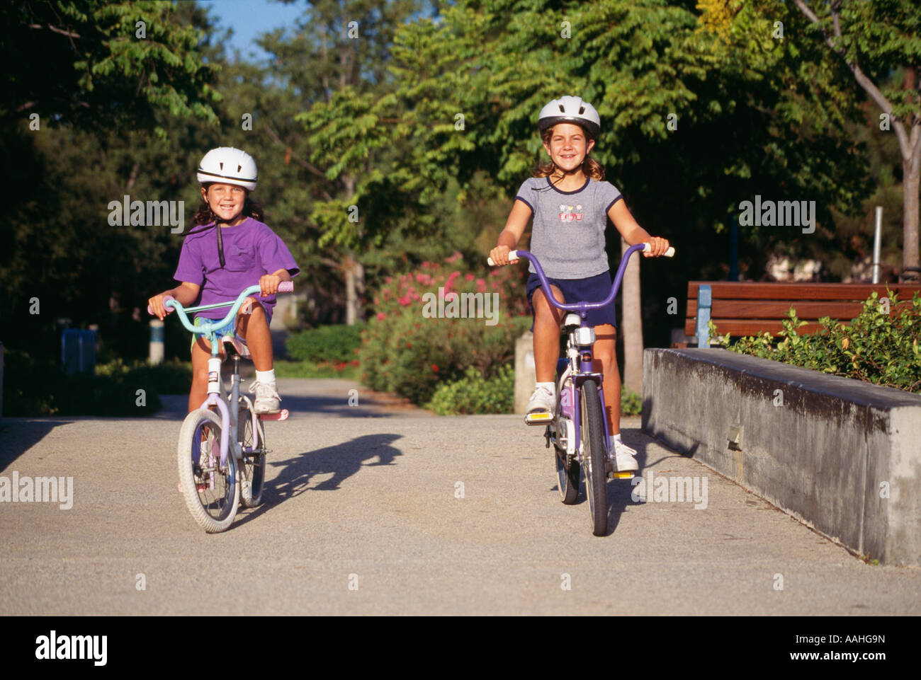 Girls children child riding bicycles bicycle bicycling  on bike bikes trail in park.Two Caucasian United States outdoor activity 5-6-7 year old ©Myrleen Pearson Stock Photo