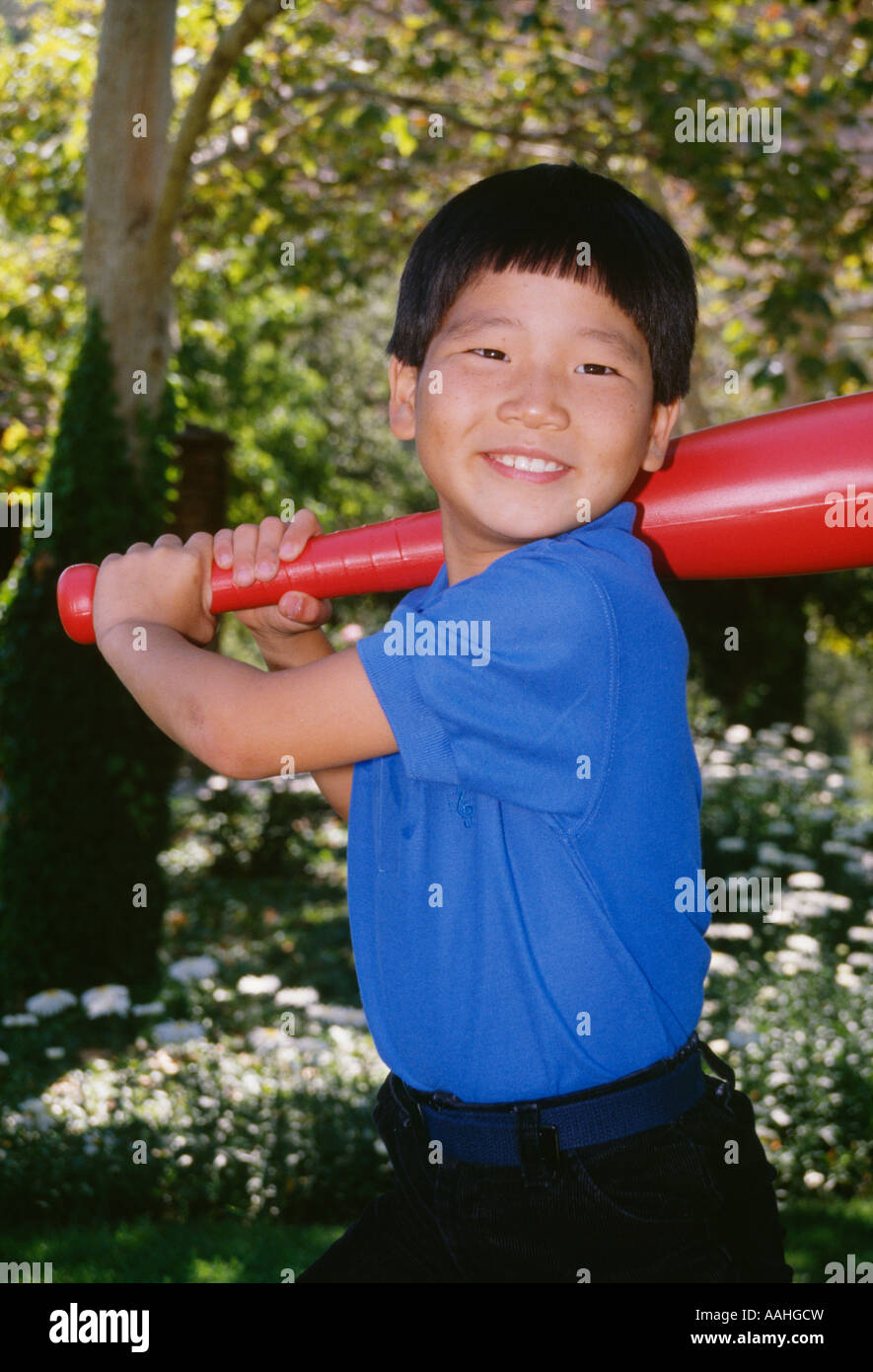 Portrait young Ethnic Korean Boy 4-5 year old holding large plastic toy baseball  bat batting Stock Photo