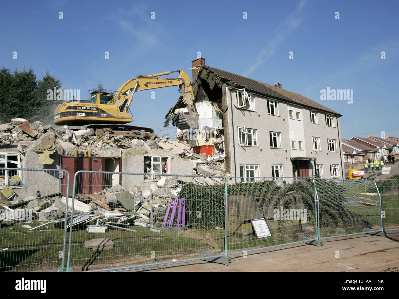 demolition. A bulldozer demolishing old council houses in Ley Hill, Northfield, Birmingham, England. Stock Photo
