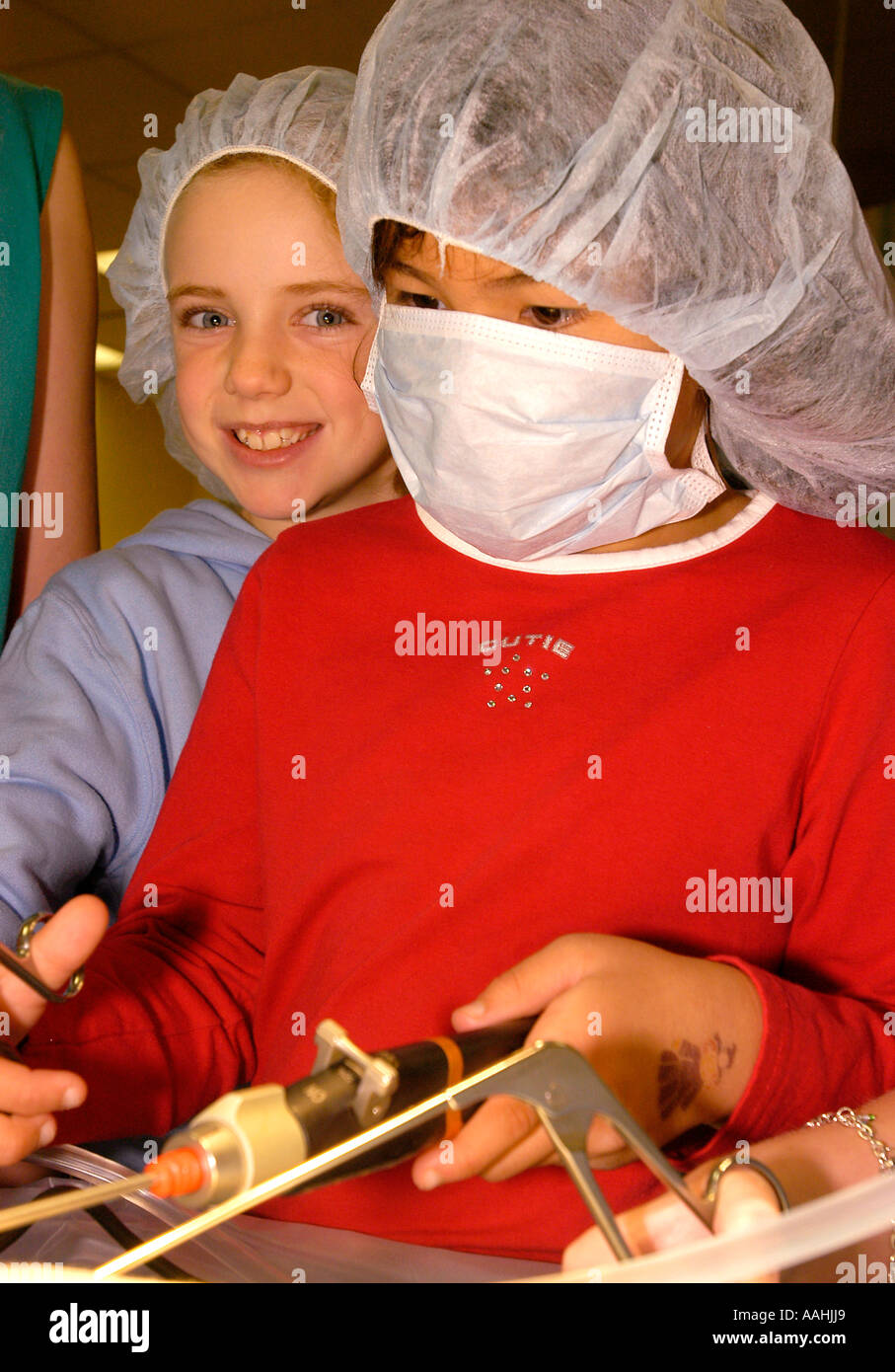 Two young girls in doctors surgical mask and hair nets try out some