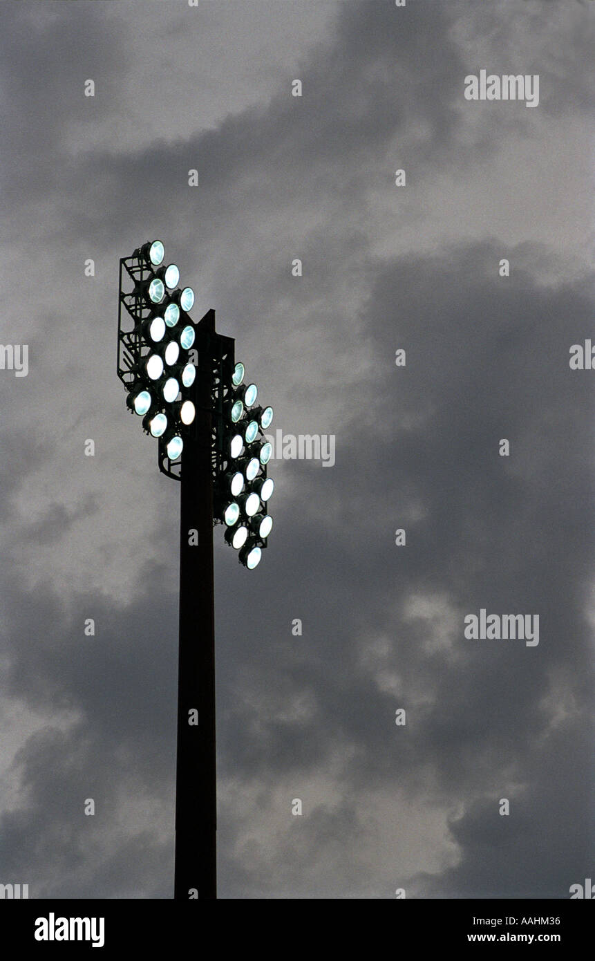 stadium floodlights lit at night with dramatic sky Stock Photo Alamy