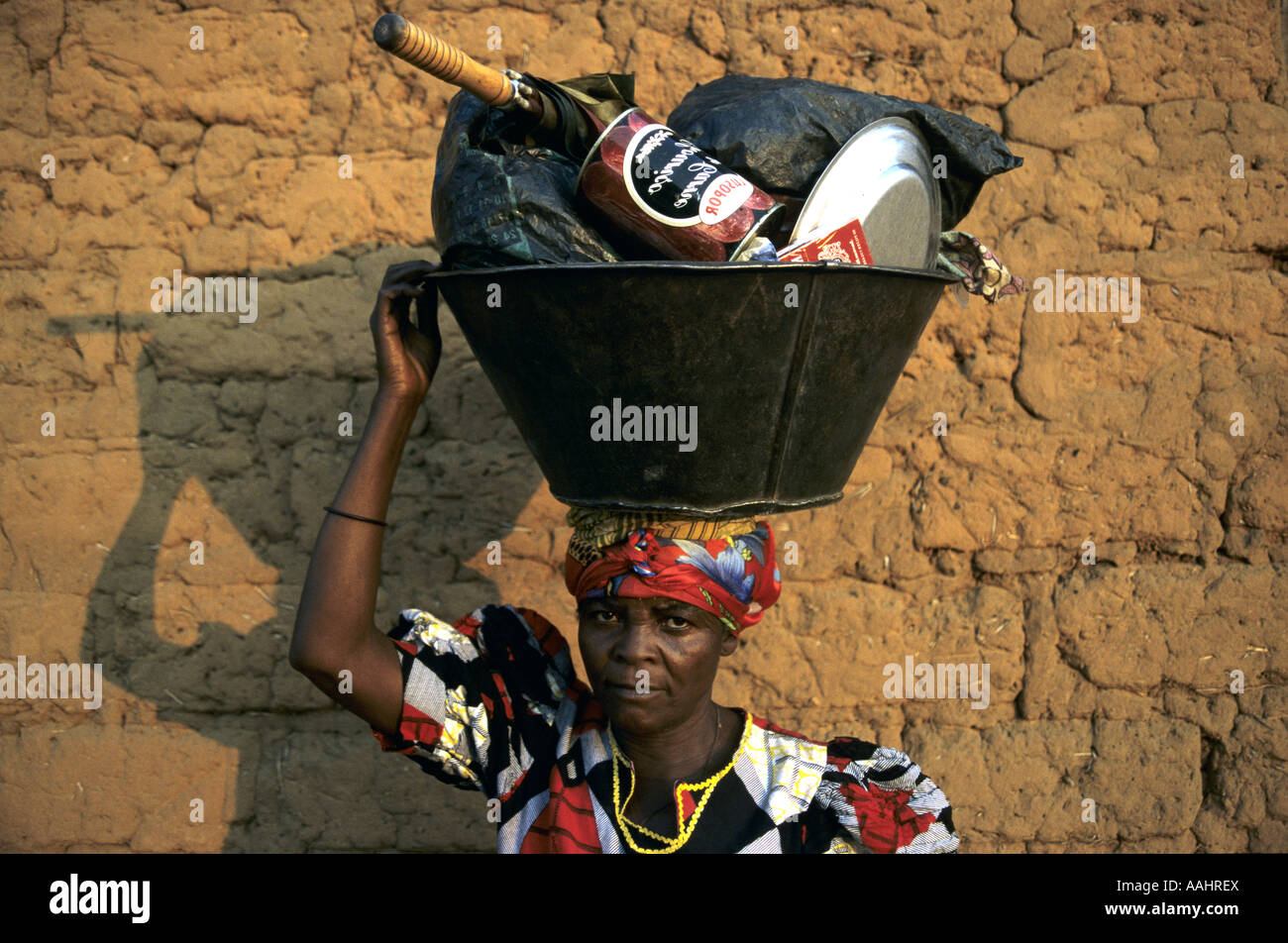 Regugee woman carrying bucket Stock Photo Alamy