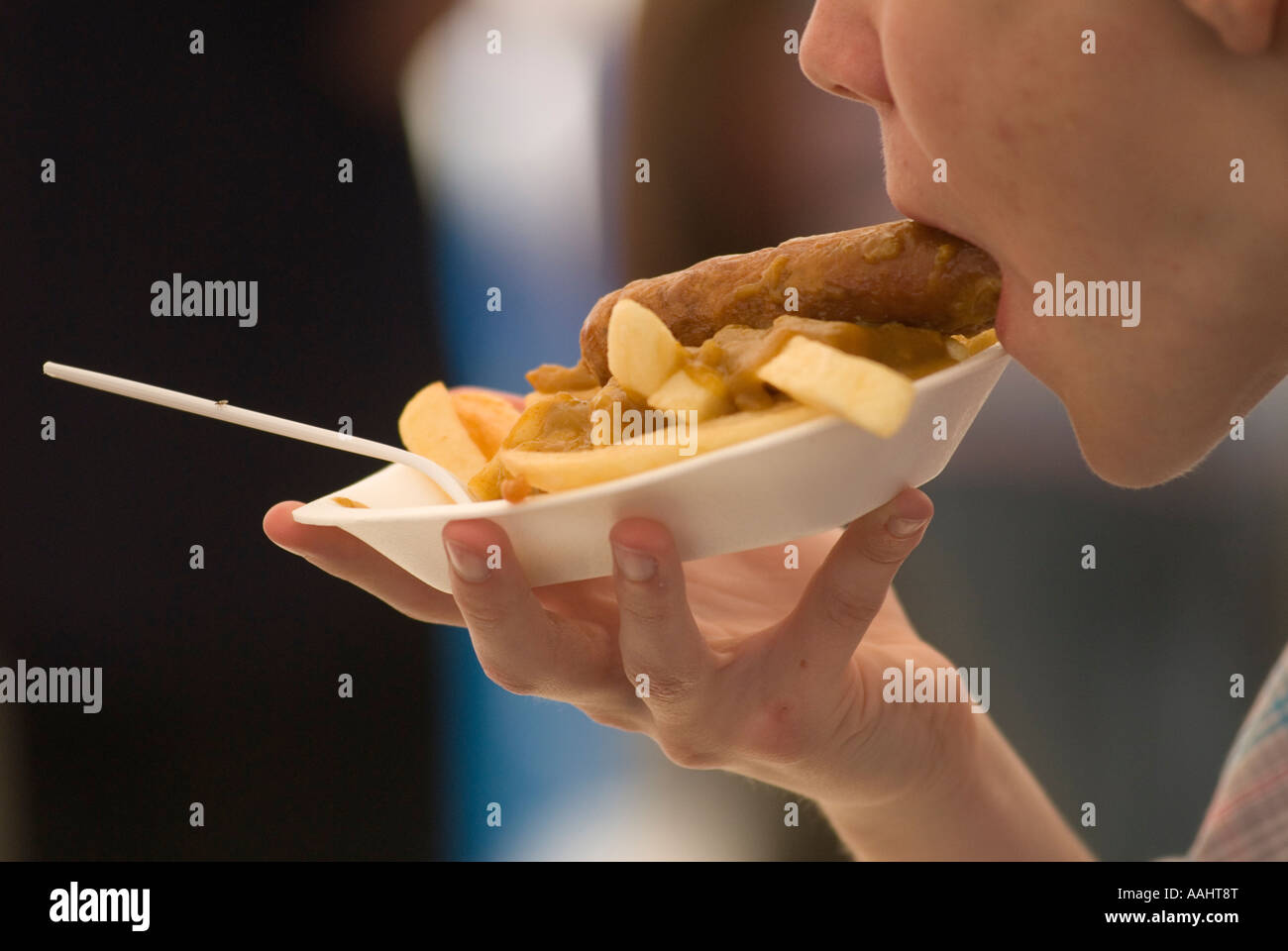 Single use polystyrene plastic plate fast Food, teen boy eating sausage and chips 2000s 2007 UK HOMER SYKES Stock Photo
