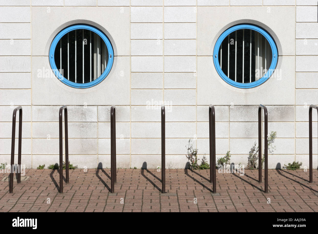 Building with round windows and Cycle Racks Stock Photo