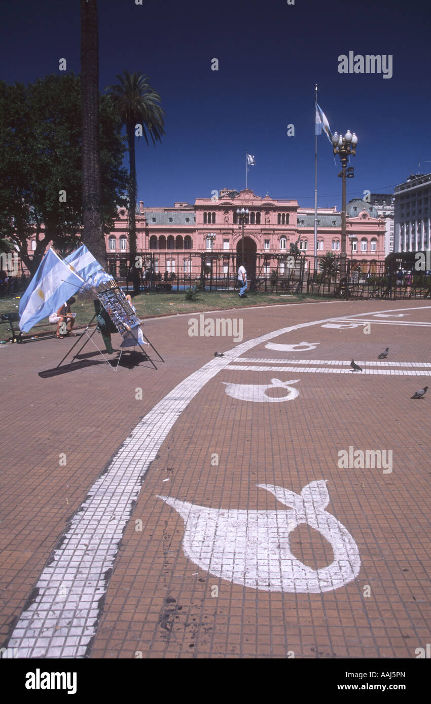 White headscarf symbols of Mothers / Madres de la Plaza de Mayo painted on pavement, Casa Rosada in background, Plaza de Mayo, Buenos Aires, Argentina Stock Photo