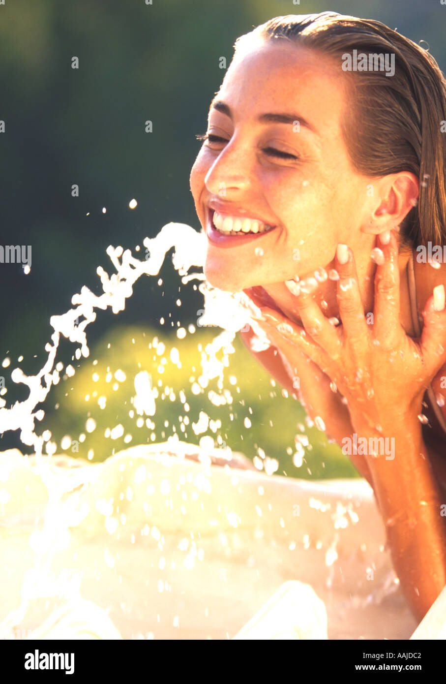 Woman splashing water face side view hi-res stock photography and ...