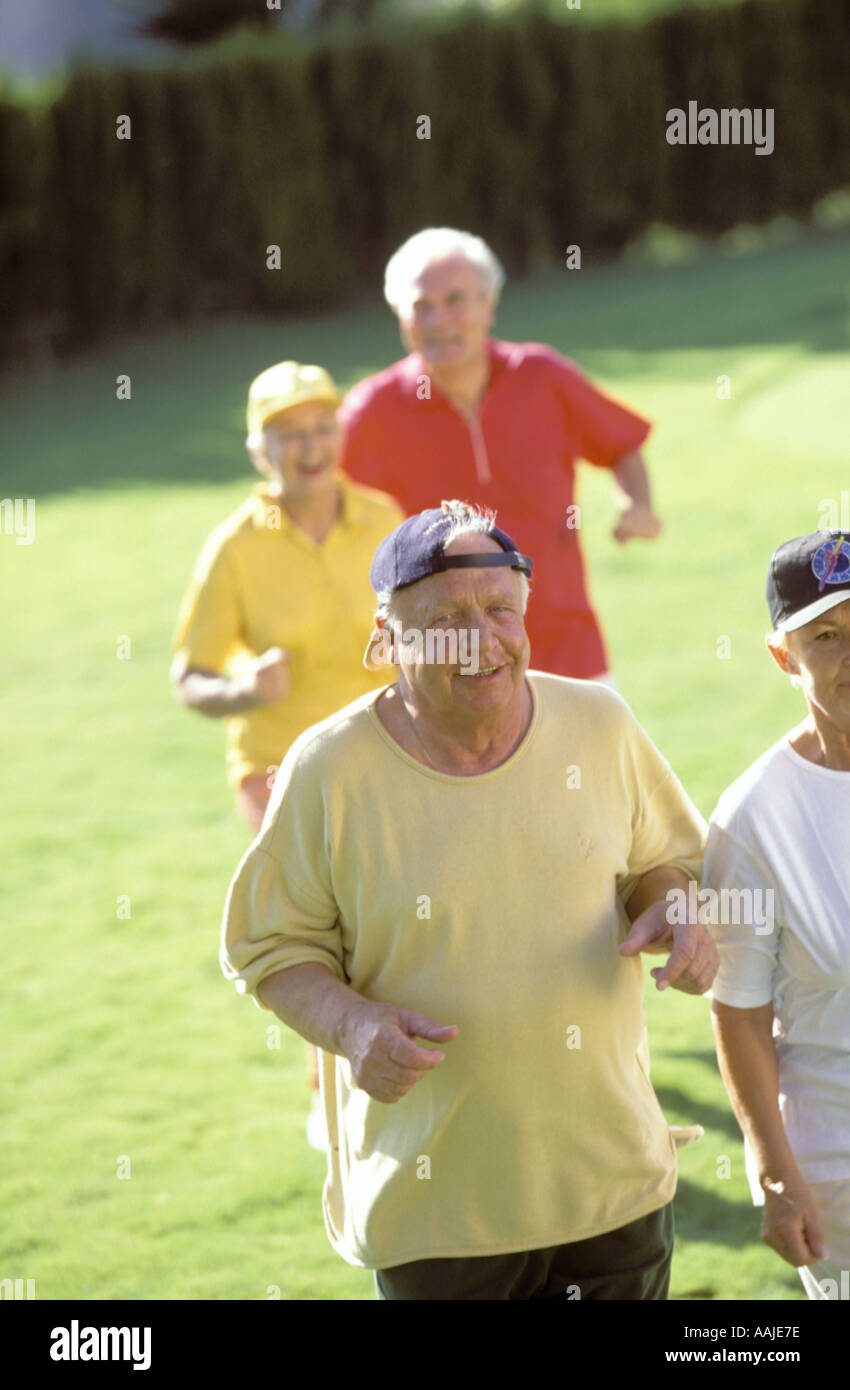 group of seniors jogging in park Stock Photo