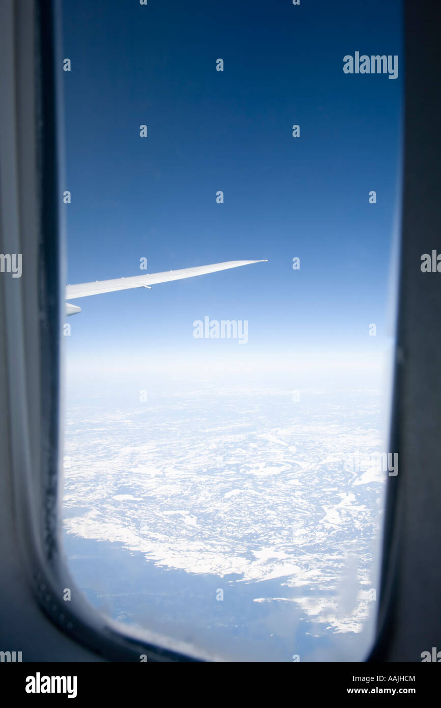 View of northern Canada from aeroplane showing window frame Stock Photo