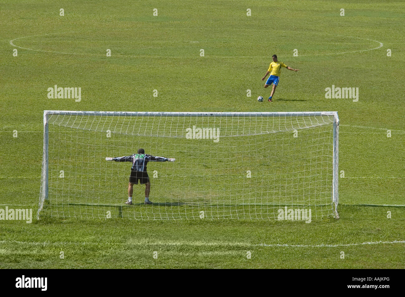 soccer player kicking ball towards goal Stock Photo Alamy