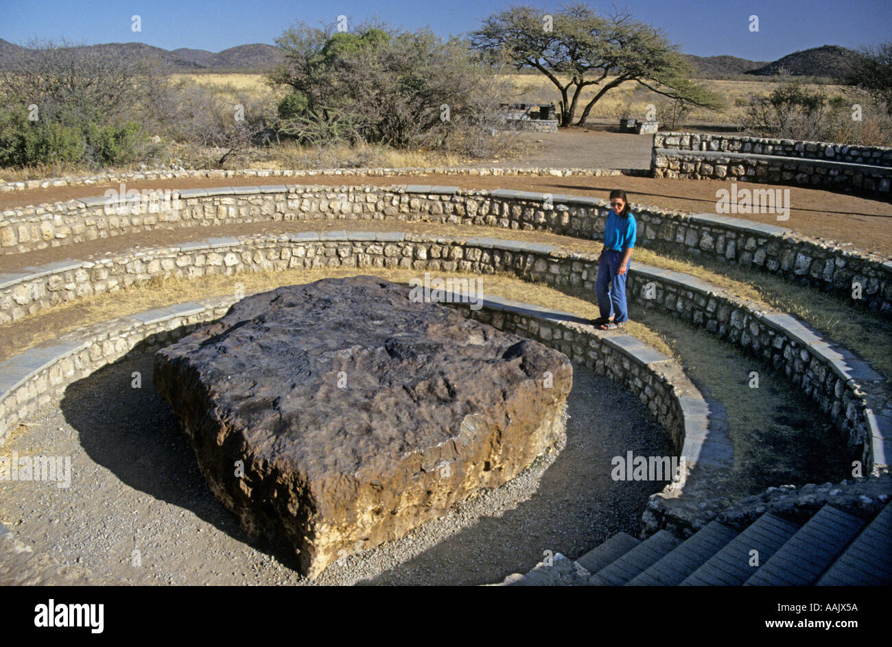 Female tourist looking at metallic meteorite Namibia Africa Stock Photo