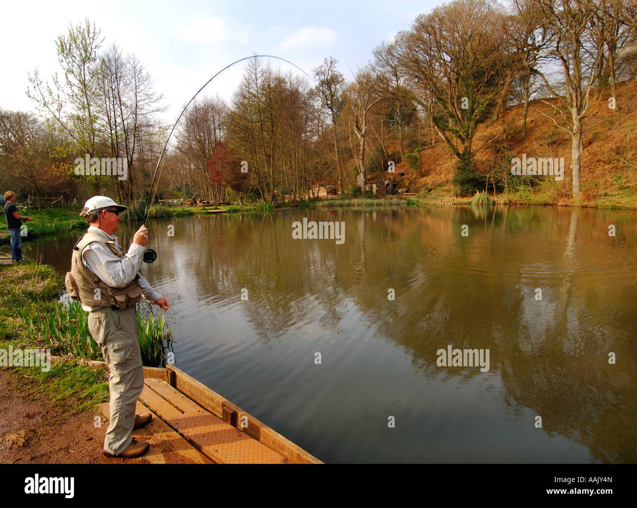 Fly fishing at Robins Lake in Robins Wood Farnham South England Stock