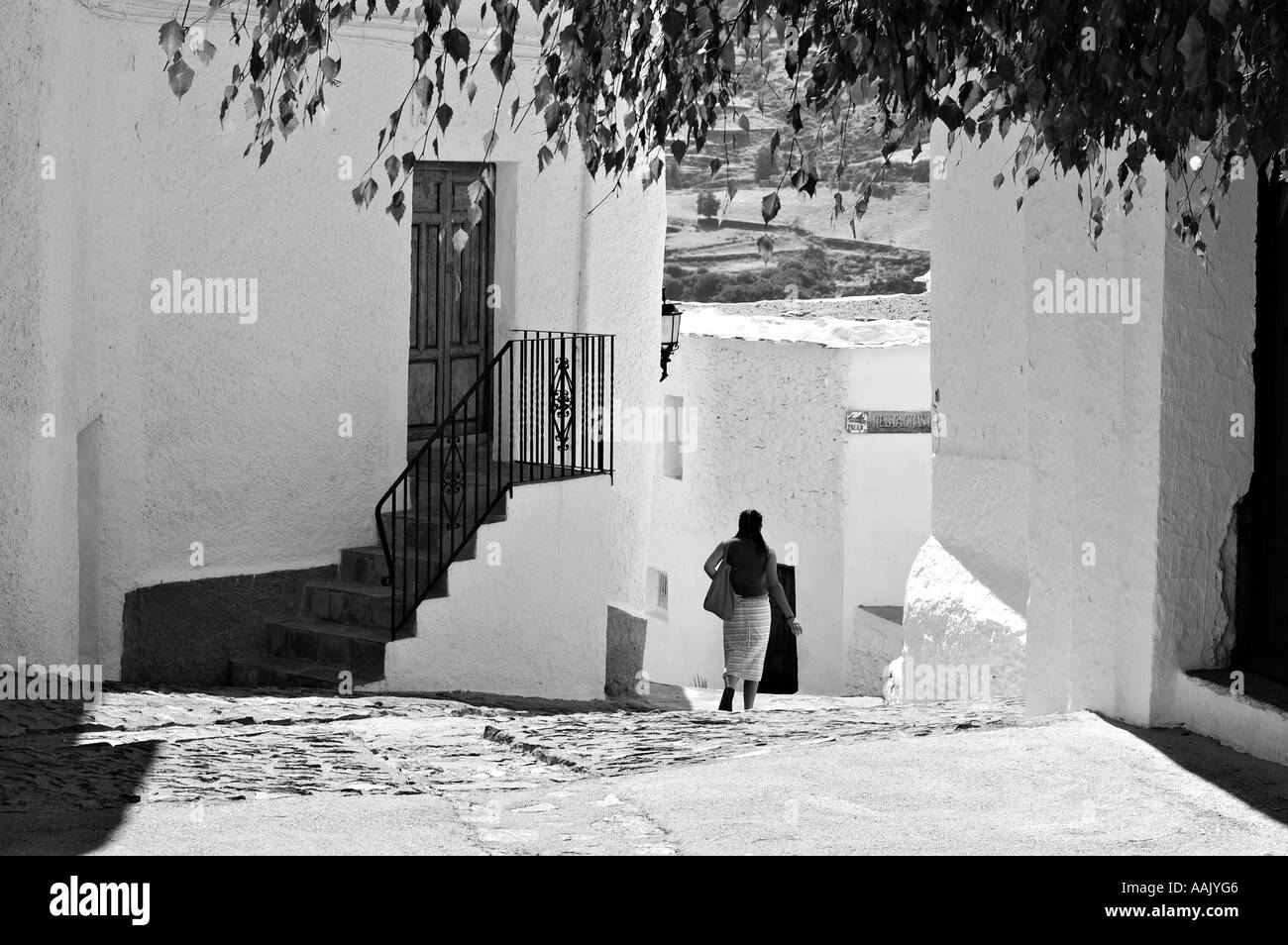lady walking in spanish pueblo Stock Photo Alamy