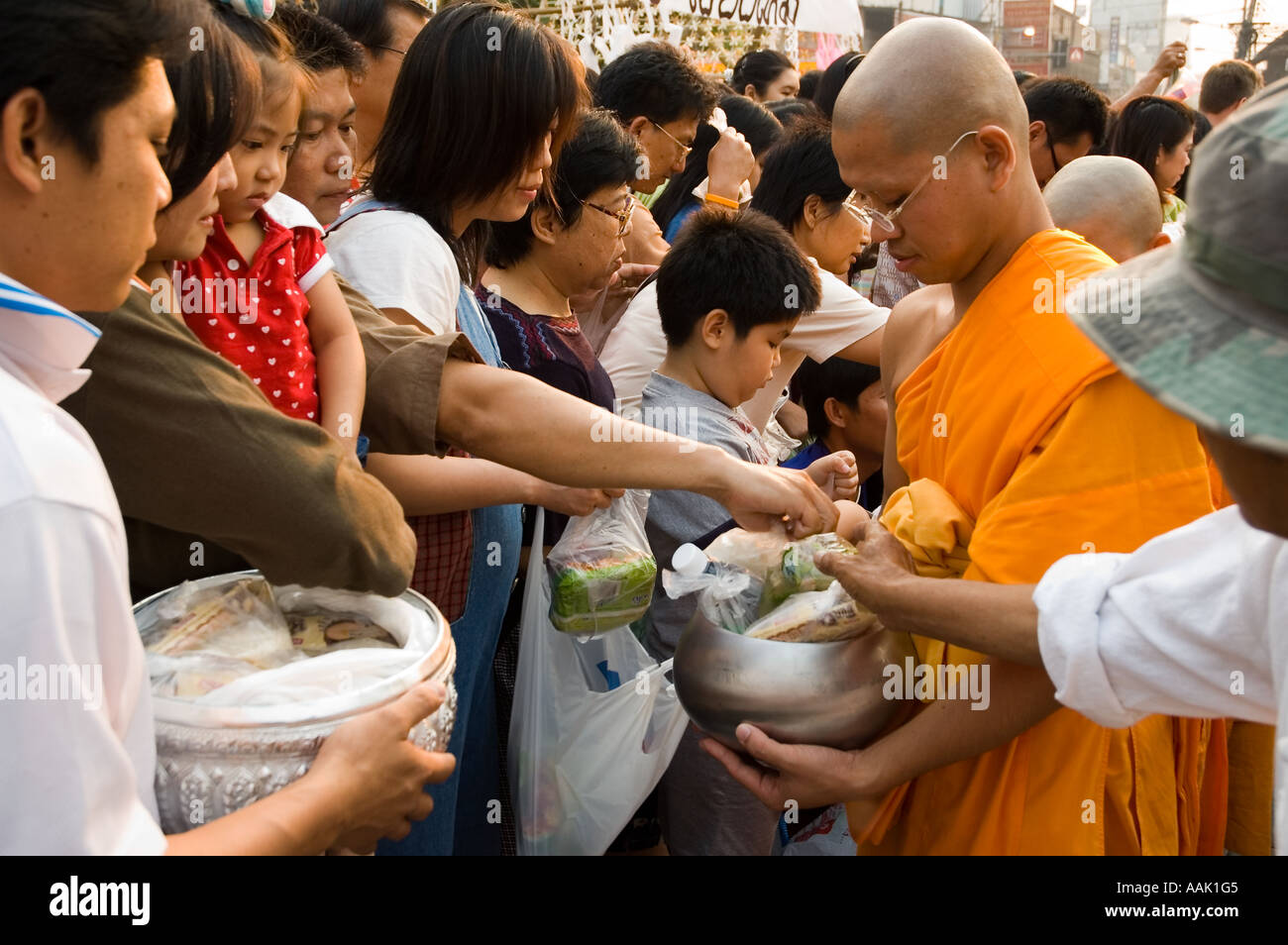 Buddhist monks participate in morning merit making ceremonies during Songkran the Thai New Year in Chiang Mai Thailand Stock Photo