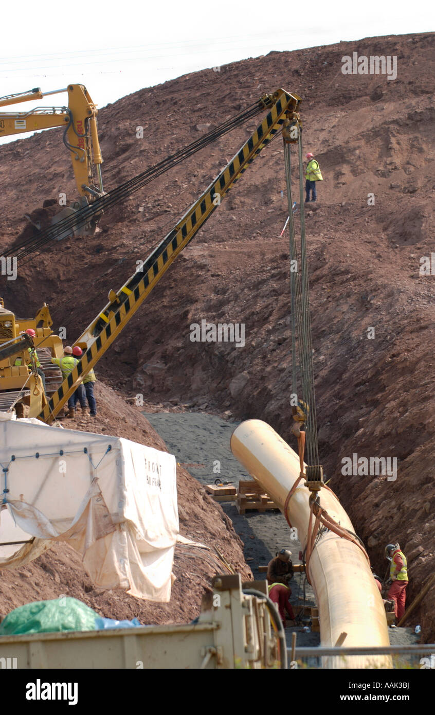 Liquified Natural Gas LNG pipeline being laid in trench over hillside