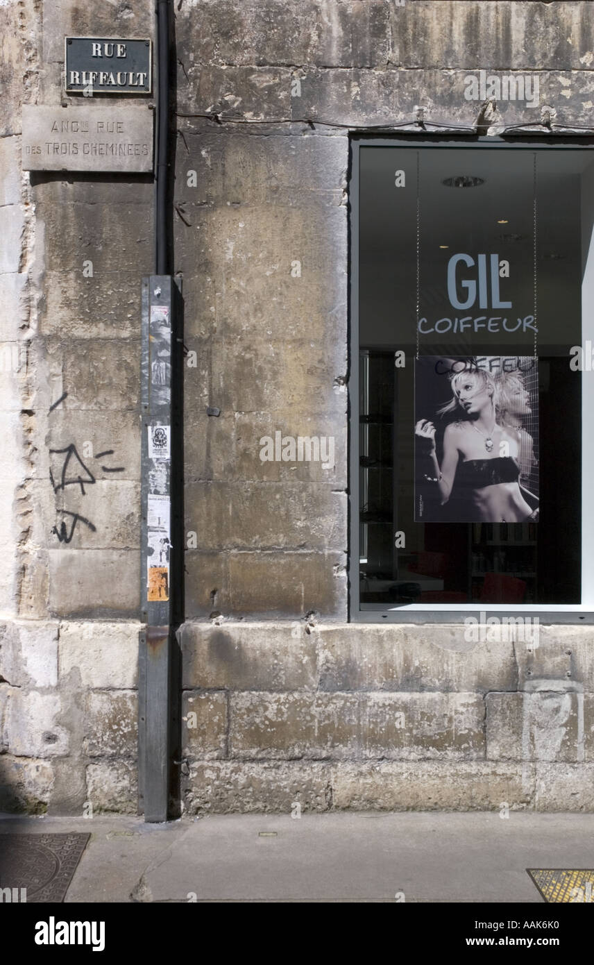 Picture of a modern hairdressers window set into an old stone building