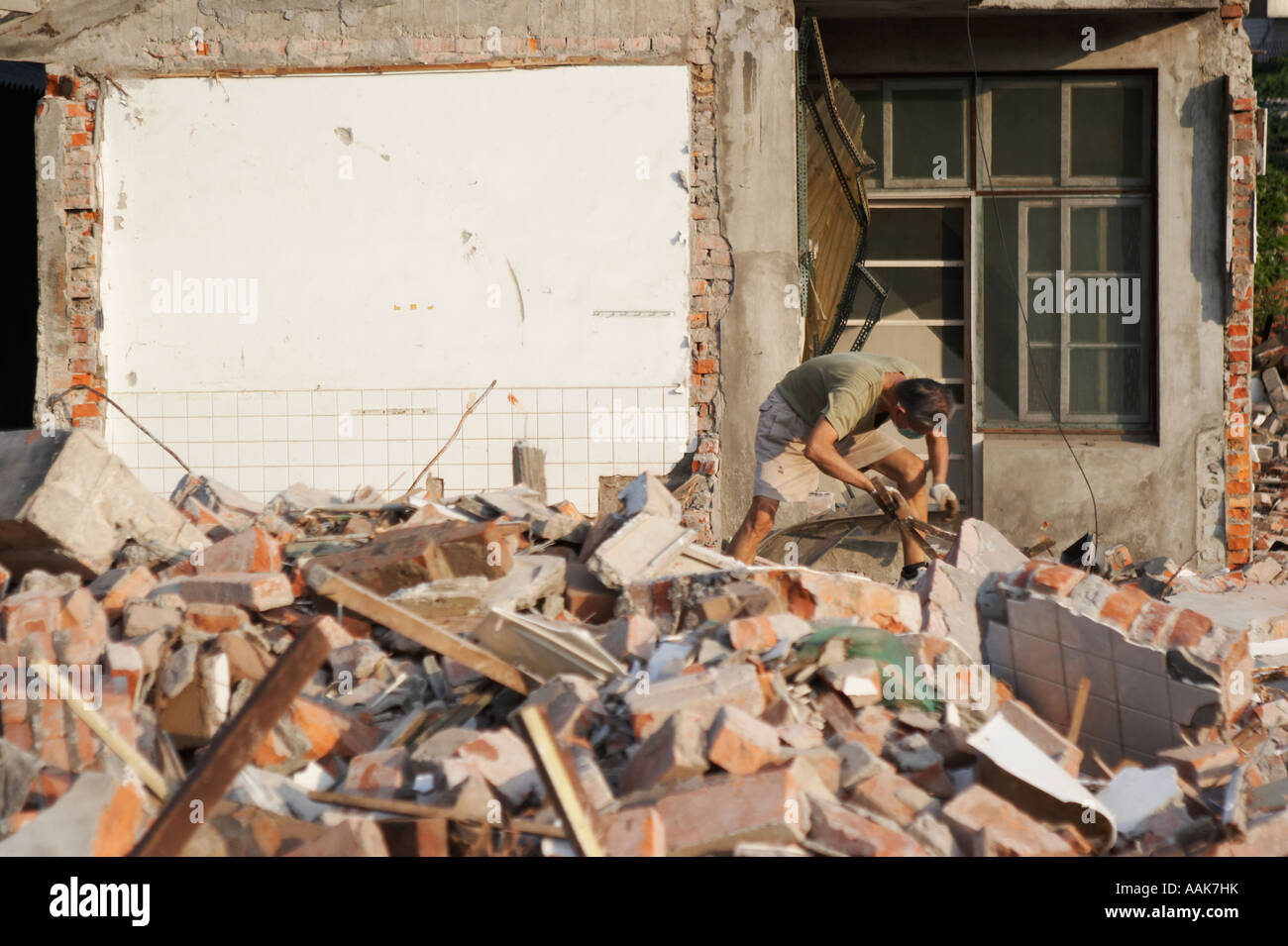 Man Scavenging Through Rubble For Scrap Stock Photo - Alamy