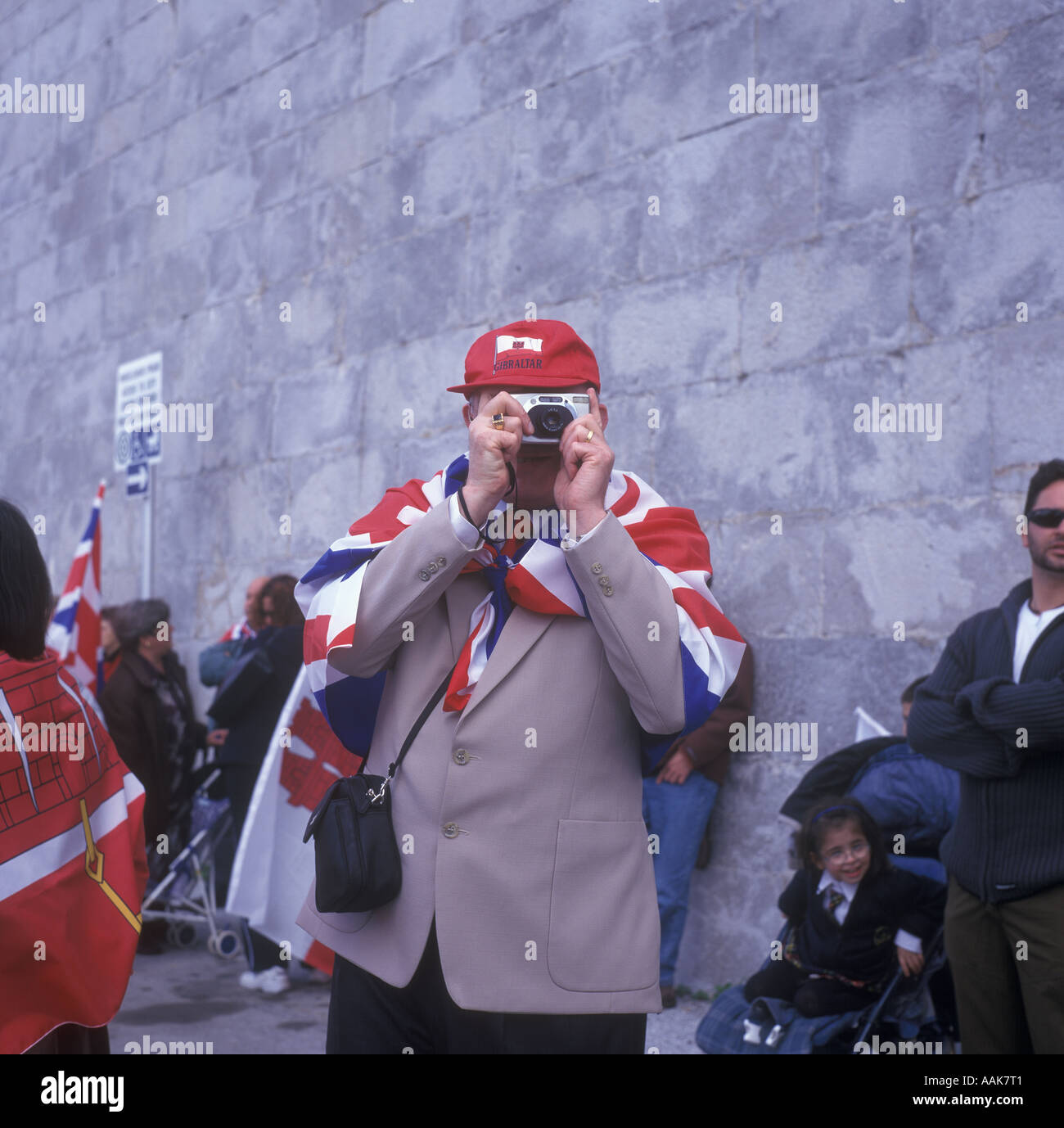 A demonstrator against Gibraltar sharing sovereignty with Spain takes a photo of a political rally, Gibraltar, 2002. Stock Photo