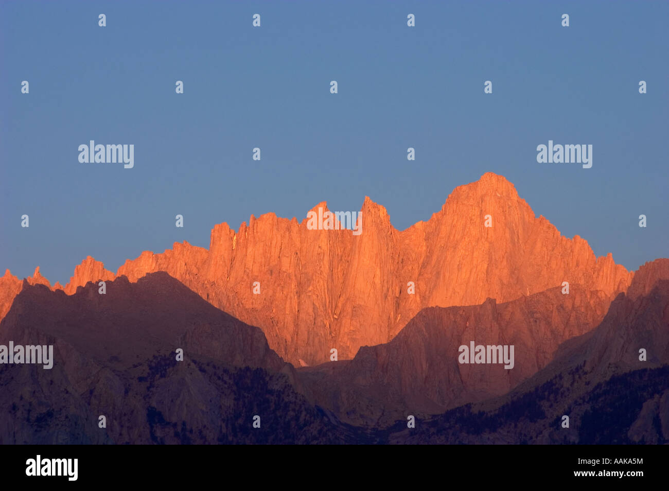 Sun hitting Mount Whitney and Whitney Portals at dawn from Alabama Hills Sierra Nevada Mountains California Stock Photo