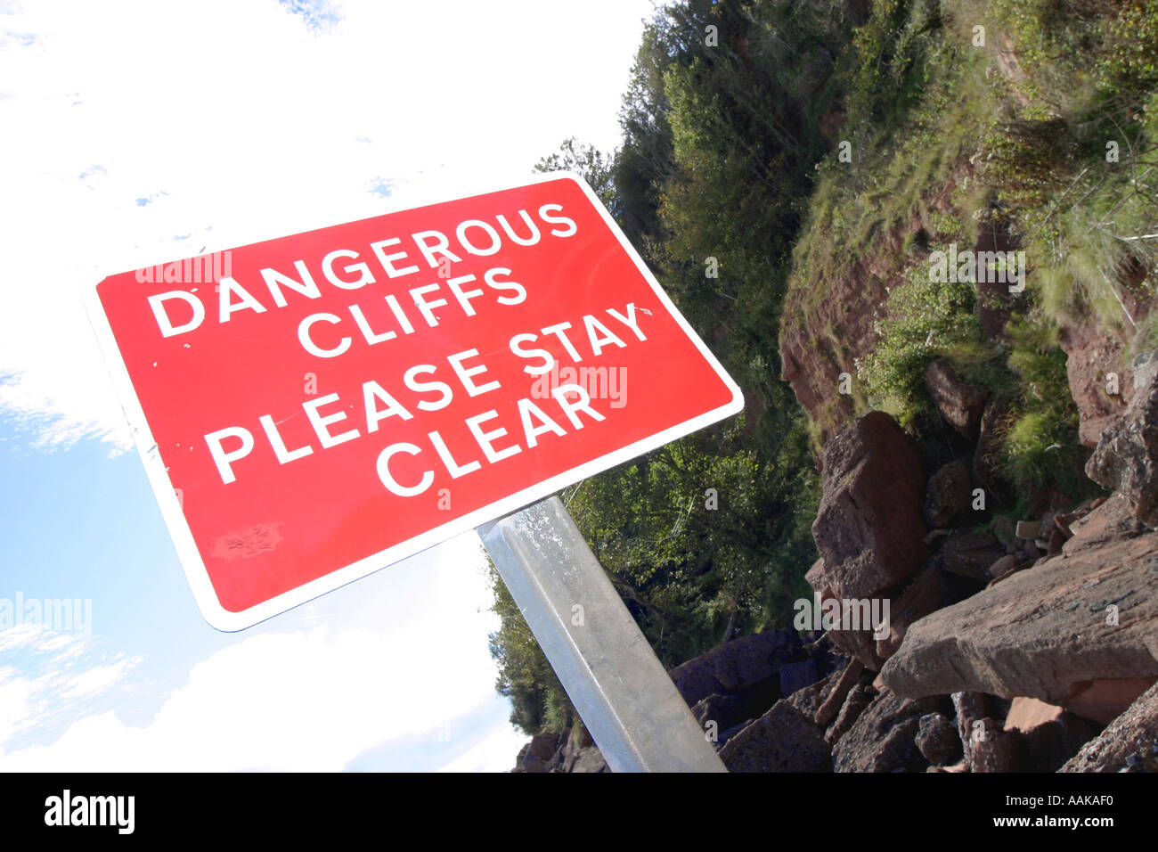 Dangerous cliffs warning sign at near Torquay Devon England