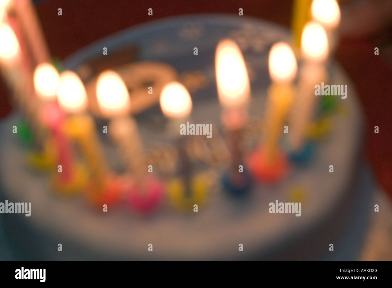 Birthday cake candles alight on cake Stock Photo - Alamy