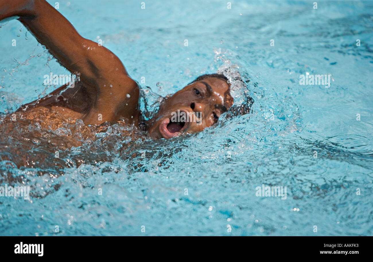 Boy swims in a school swimming race Stock Photo