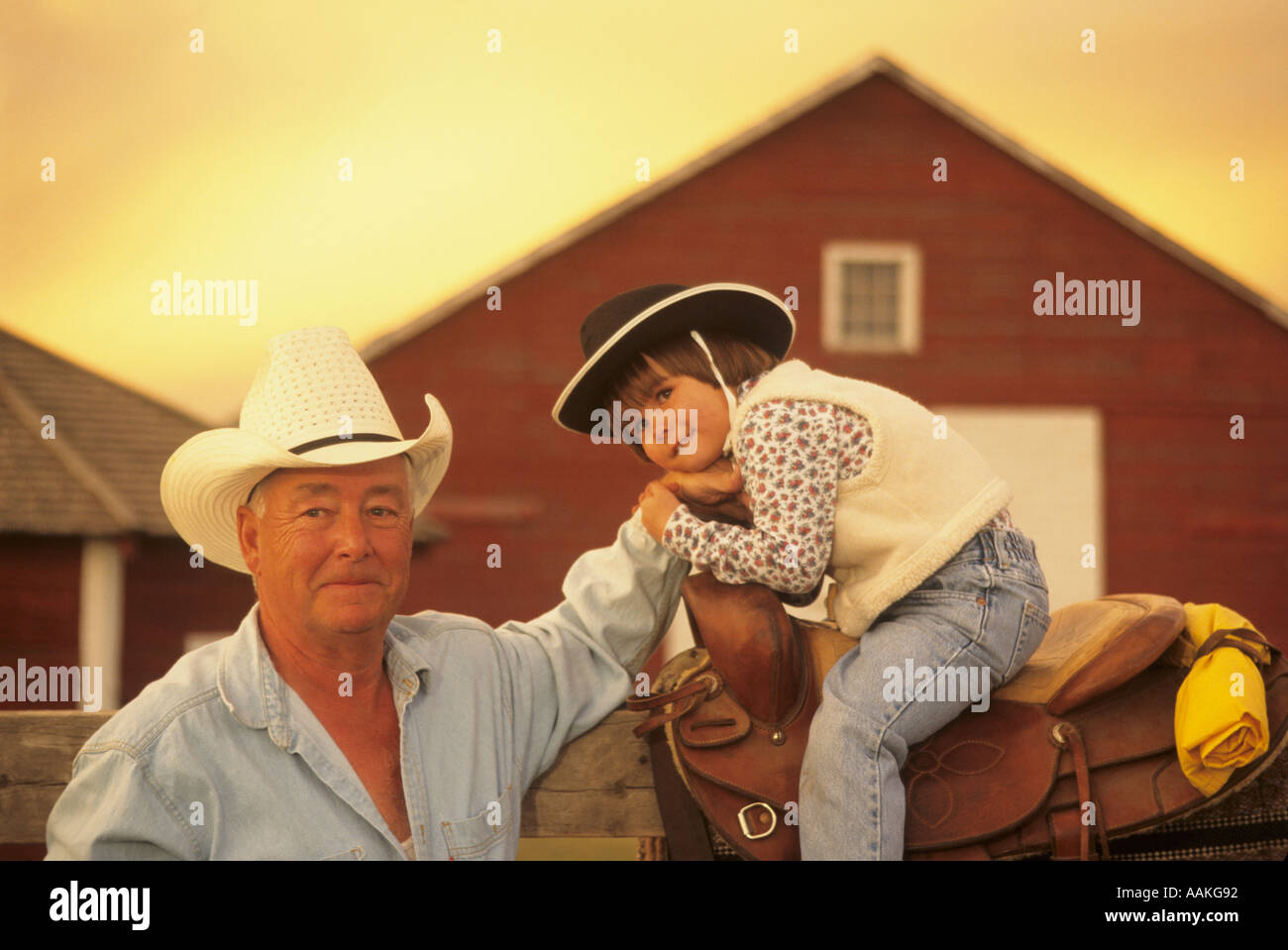 Cowboy and child Stock Photo - Alamy