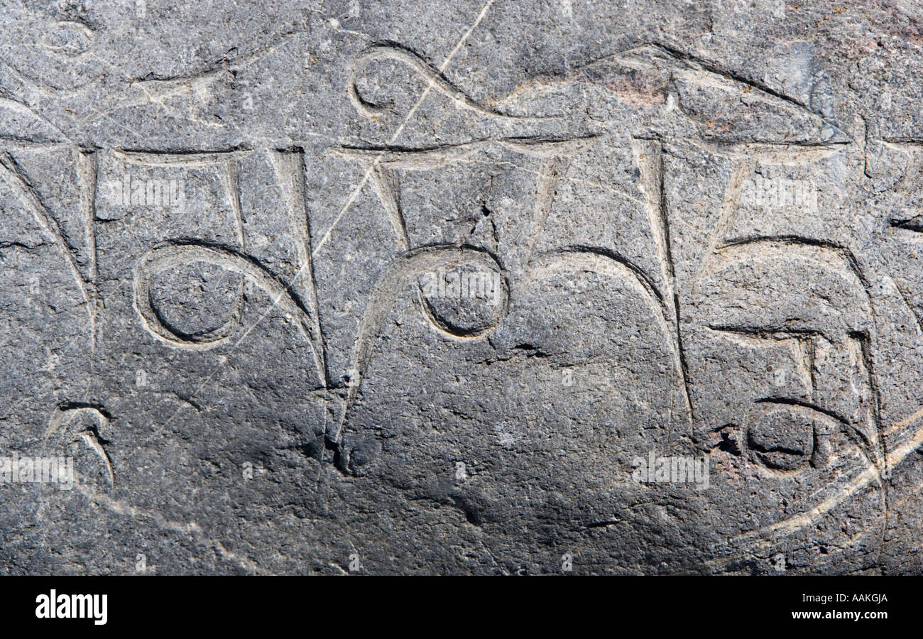 Om mani padmi hum Carved into one of the stones used to build a mani wall Annapurna circuit trek Himalayas Nepal Stock Photo