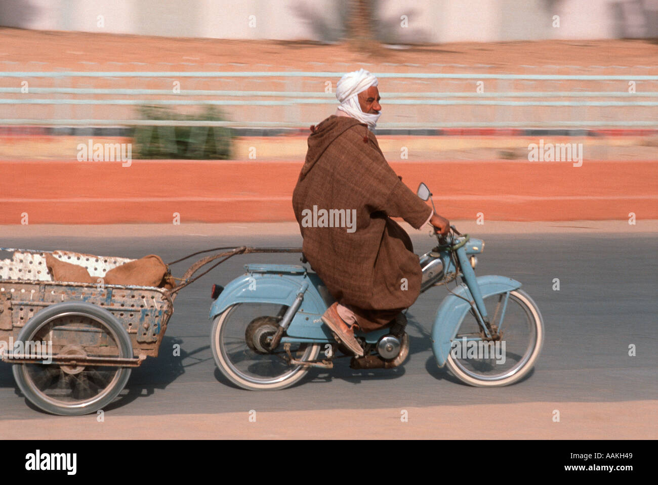 Arab man travelling on a moped in Algeria Stock Photo