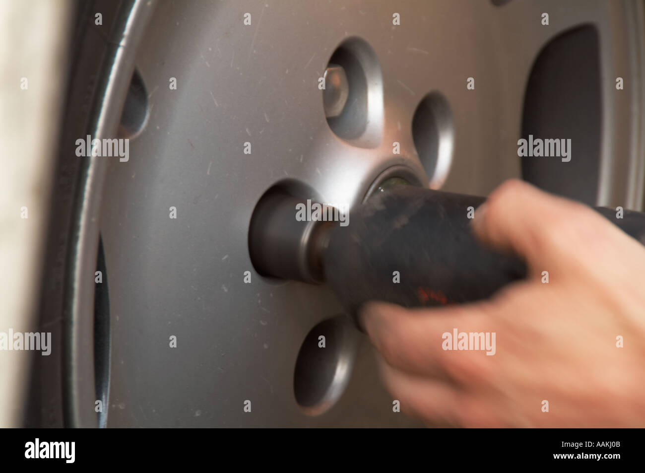 mechanic unbolting car wheel tire change tyre puncture garage bolt nut