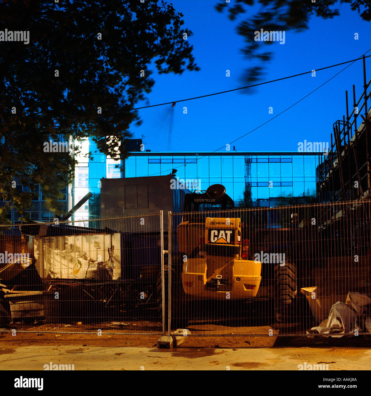 dusk shot of building site London inc Caterpillar digger Stock Photo